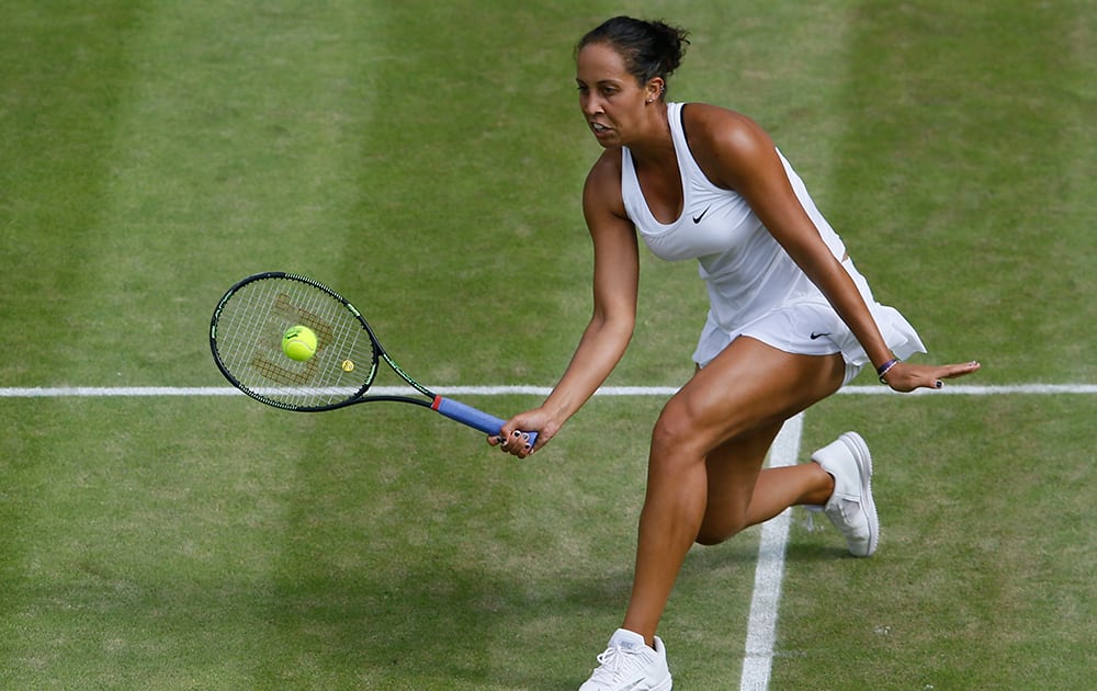 Madison Keys of the United States returns a ball to Agnieszka Radwanska of Poland during their singles match at the All England Lawn Tennis Championships in Wimbledon.