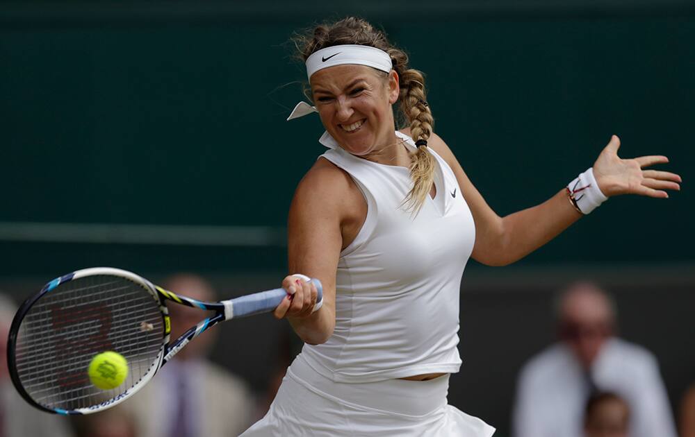 Victoria Azarenka of Belarus makes a return to Serena Williams of the United States during their singles match at the All England Lawn Tennis Championships in Wimbledon, London.