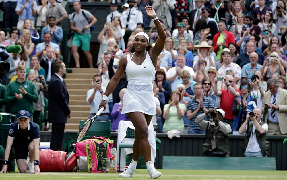 Serena Williams of the United States celebrates winning the singles match against Victoria Azarenka of Belarus, at the All England Lawn Tennis Championships in Wimbledon, London.