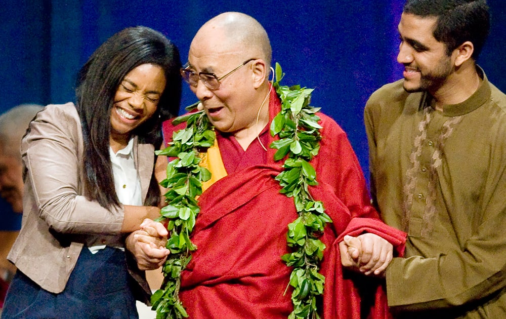 Actress Regina King, shares a laugh with the Dalai Lama after she remarked how handsome he is during his three day 80th Birthday and Global Compassion Summit at the University of California, Irvine, in Irvine, Calif. 