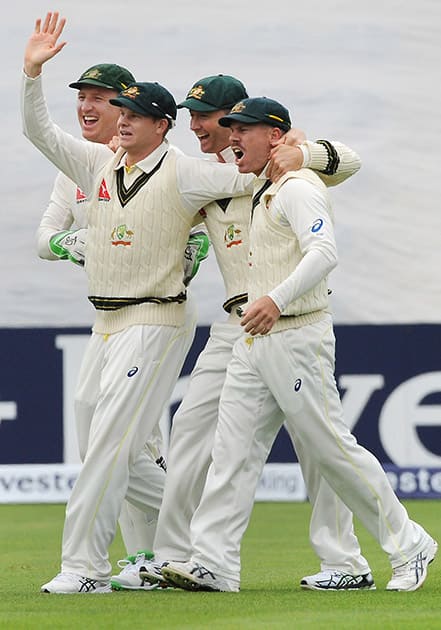 Australia’s Brad Haddin, Steve Smith, Michael Clarke and David Warner, celebrates the wicket of England’s Adam Lyth during day one of the first Ashes Test cricket match, in Cardiff, Wales.