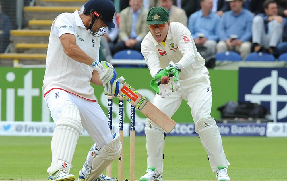 England captain Alastair Cook is caught by Australia’s Brad Haddin bowled by Australia's Nathan Lyon for 20 runs during day one of the first Ashes Test cricket match, in Cardiff, Wales.