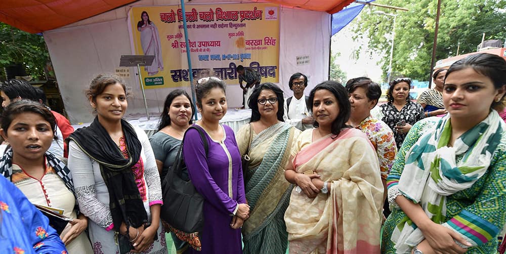 Aam Aadmi Party (AAP) leader Somnath Bhartis wife Lipika Mitra with Delhi Commission for Women chairperson Barkha Shukla Singh, Congress leader Sharmistha Mukherjee and others during a dharna organised by Sashakt NARI Parishad at Jantar Mantar in New Delhi.