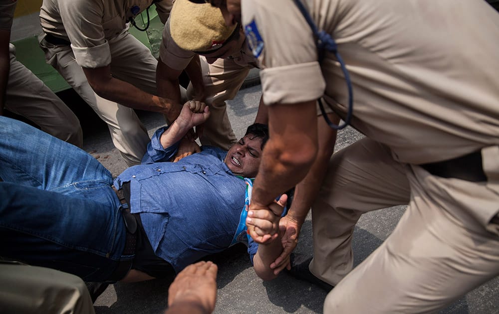 An activist of India's Congress party's youth wing is detained during a protest against Shivraj Singh Chauhan, chief minister of the central Indian state of Madhya Pradesh, in New Delhi.