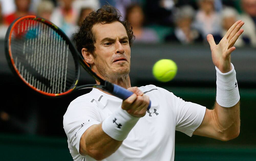 Andy Murray of Britain returns a shot to Vasek Pospisil of Canada during the men's quarterfinal singles match at the All England Lawn Tennis Championships in Wimbledon, London.