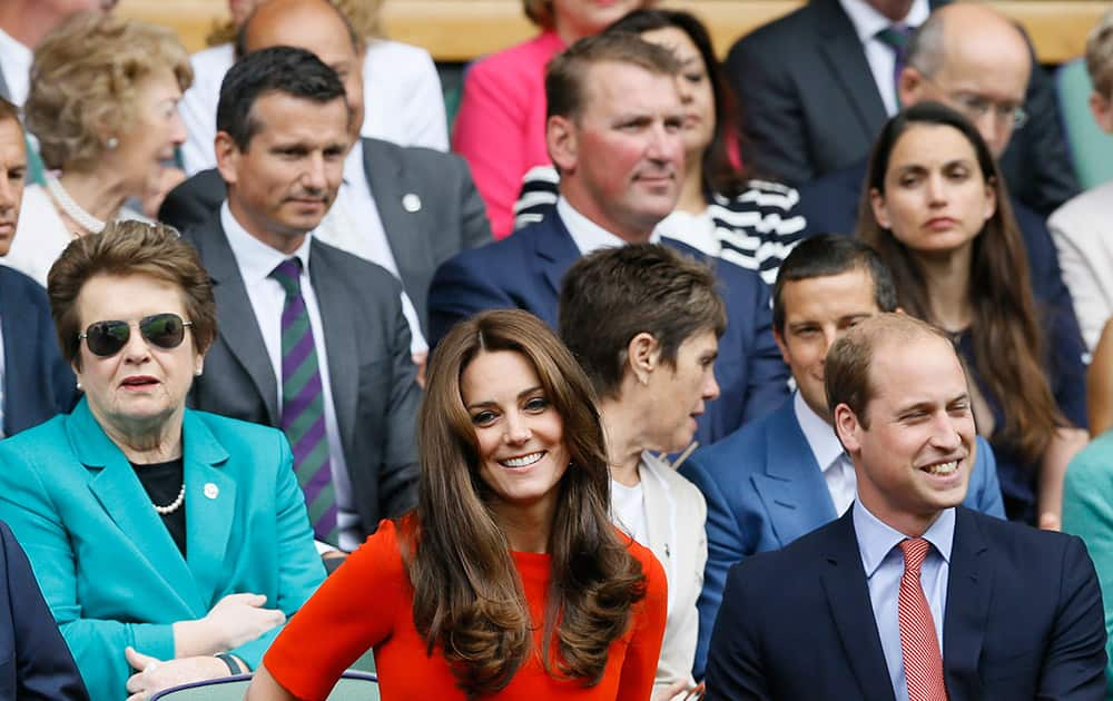 Britain’s Prince William, the Duke of Cambridge and Kate, the Duchess of Cambridge sit on Centre Court, with former Wimbledon Champion Billie Jean King in background left, at the All England Lawn Tennis Championships in Wimbledon, London.