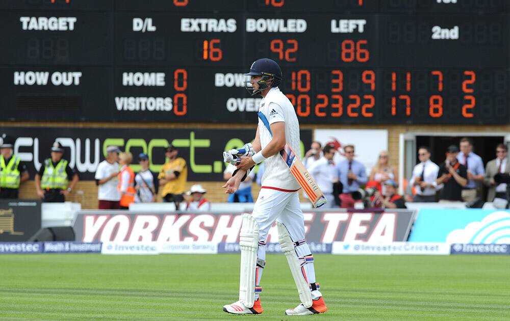 England's Stuart Broad walks back to the crease after a third umpire decision ruled not out during day two of the first Ashes Test cricket match, in Cardiff, Wales.