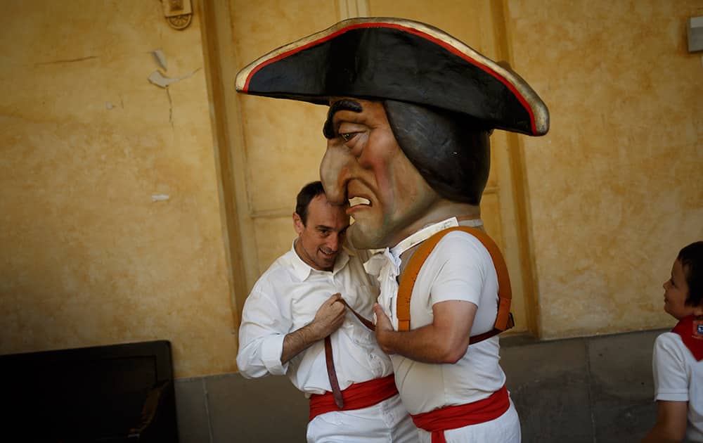 A 'Kiliki' or Big Head gets ready before taking part on the daily 'Comparsa de gigantes y cabezudos' (Parade of the Giants and Big Heads) parade of the San Fermin festival in Pamplona, Spain.