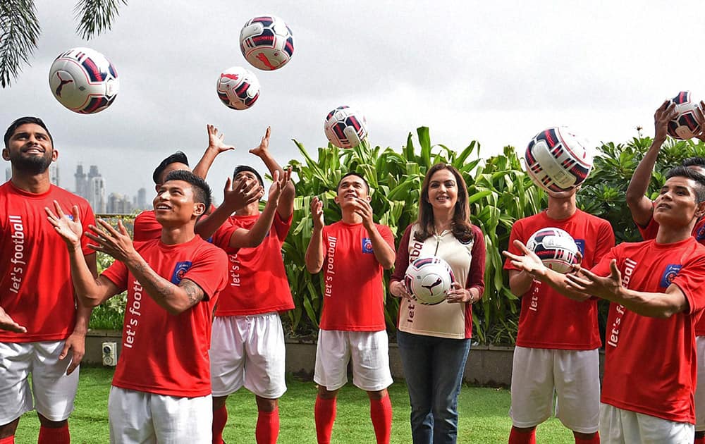 Founder and chairperson of Football Sports Development Limited (FSDL) Nita Ambani with football players during the auction of the Indian Super League (ISL) teams in Mumbai.