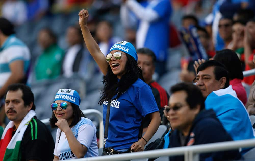 Guatemala fans cheer during the first half of the team's CONCACAF Gold Cup soccer match against Trinidad and Tobago.