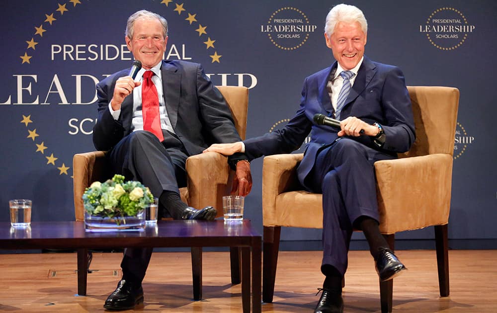 Former Presidents George W. Bush, left, and Bill Clinton joke back and forth during the Presidential Leadership Scholars Graduation at the George W. Bush Presidential Center in University Park, Texas.