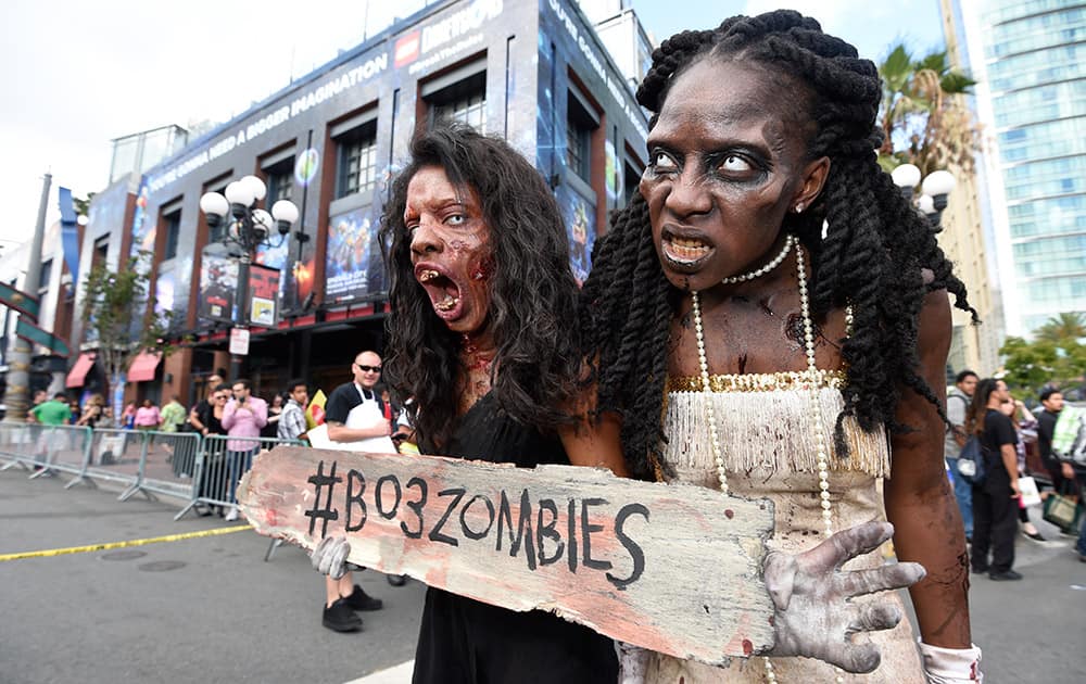 Two zombies wander through the Gaslamp District on first day of the 2015 Comic-Con International held at the San Diego Convention Center, in San Diego.