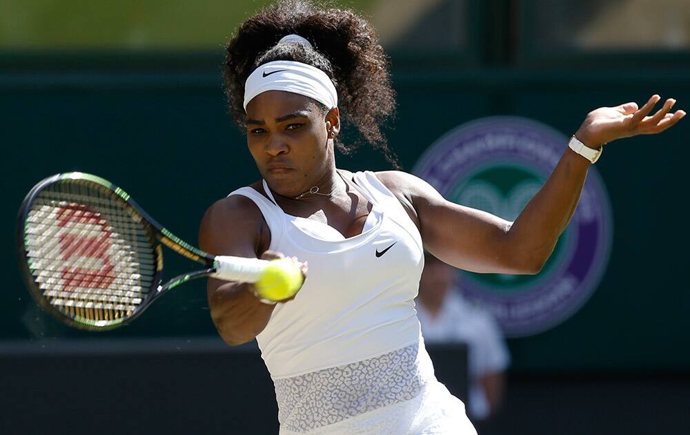 Serena Williams of the United States returns a shot to Maria Sharapova of Russia, during the women's singles semifinal match at the All England Lawn Tennis Championships in Wimbledon, London.