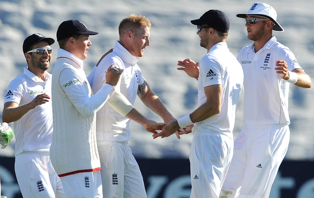 England’s Ben Stokes, celebrates with James Anderson, after Australia’s Adam Voges was bowled by Ben Stokes caught James Anderson for 31 runs during day two of the first Ashes Test cricket match, in Cardiff, Wales.