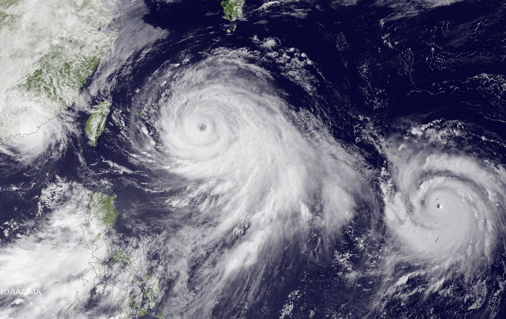 This satellite image taken by the JMA MTSAT-2 satellite at 9;30 a.m. EDT, shows Tropical Storm Linfa, left, tracking westward parallel to the coast of China, and Typhoon Chan-hom, over the Ryukyu Trench south of Okinawa, Japan, on a track heading northwest toward the China coast north of Wenzhou. 