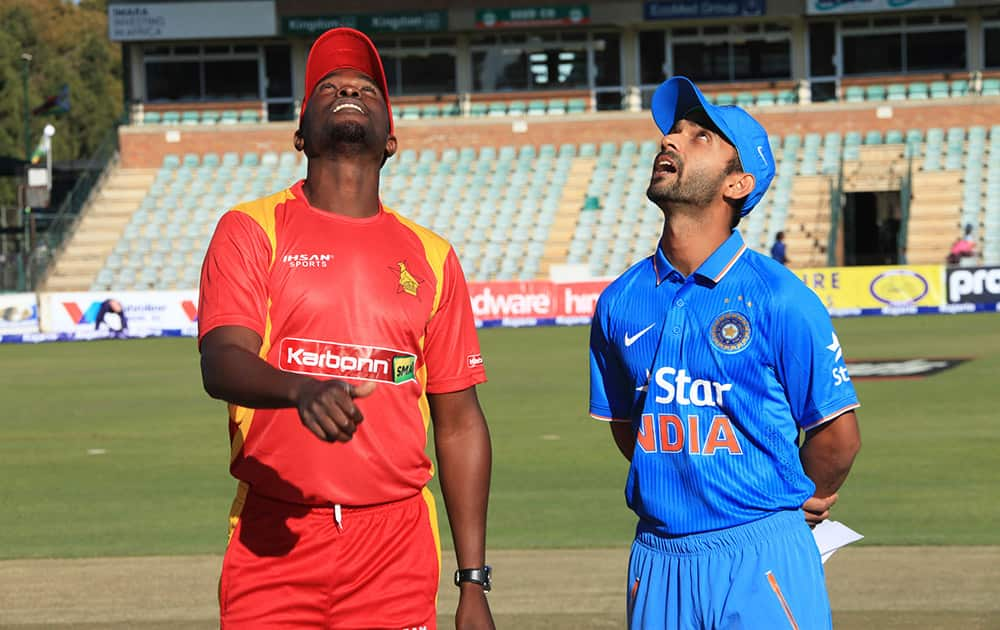 Zimbabwean captain Elton Chigumbura and Indian captain Ajinkya Rahane attend the toss during the first One Day International in Harare, Zimbabwe.