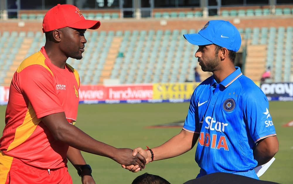 Zimbabwean captain Elton Chigumbura and Indian captain Ajinkya Rahane shake hands after the toss during the first One Day International between the two teams in Harare, Zimbabwe.