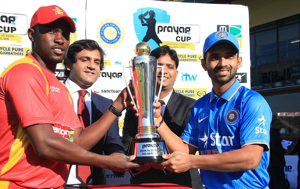 Zimbabwean captain Elton Chigumbura and Indian cricket captain Ajinkya Rahane hold the trophy before the  first One Day International between the two teams in Harare, Zimbabwe.