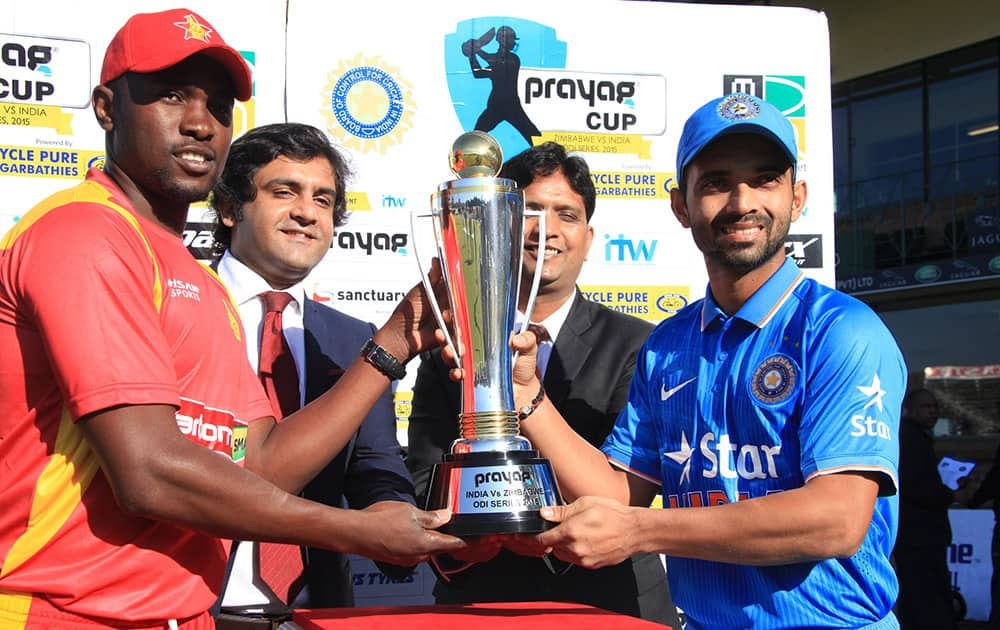 ZIMBABWEAN CAPTAIN ELTON CHIGUMBURA AND INDIAN CRICKET CAPTAIN AJINKYA RAHANE HOLD THE TROPHY BEFORE THE FIRST ONE DAY INTERNATIONAL BETWEEN THE TWO TEAMS IN HARARE, ZIMBABWE.