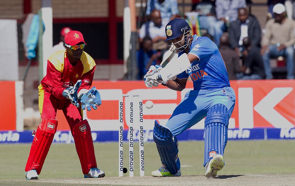 Stuart Binny plays a shot while Zimbabwean wicketkeeper Richmond Mutumbami looks onduring the first One Day International against Zimbabwe in Harare.