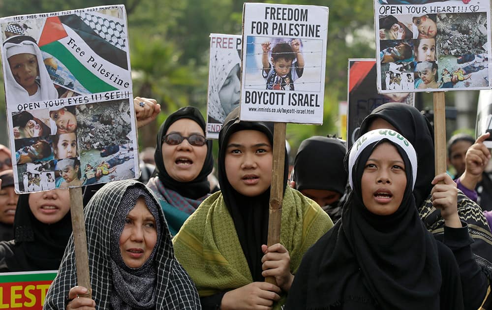 Muslim protesters shout slogans in a rally marking International Al-Quds Day outside the U.S. Embassy in Jakarta, Indonesia.