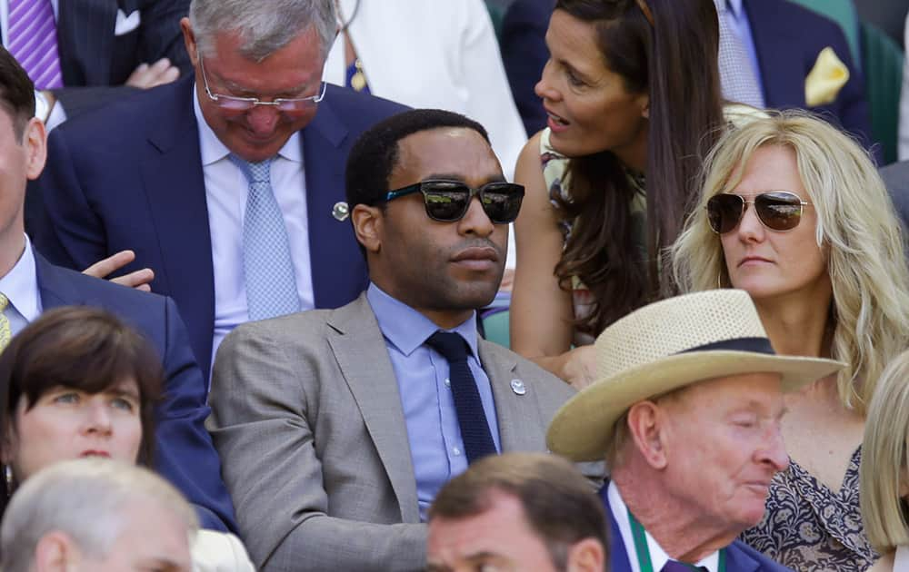 British actor Chiwetel Ejiofor sits in the Royal Box, on Centre Court, ahead of the men's singles semifinal matches, at the All England Lawn Tennis Championships in Wimbledon, London.