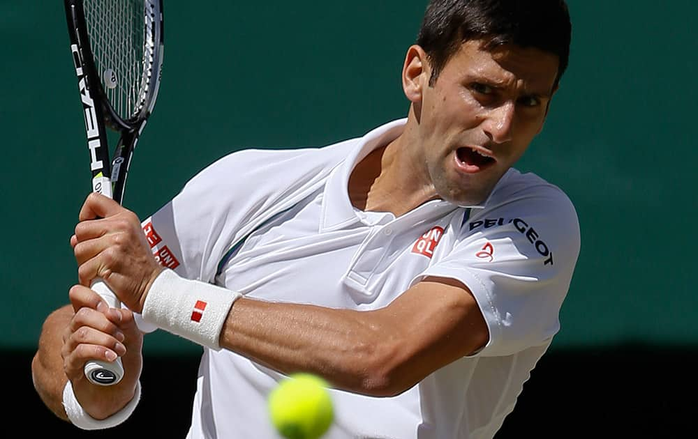 Novak Djokovic of Serbia returns a shot to Richard Gasquet of France during the men's singles semifinal match at the All England Lawn Tennis Championships in Wimbledon, London.