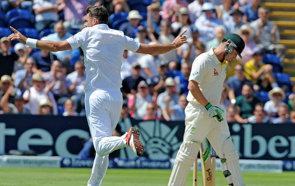 England’s James Anderson celebrates after bowling Australia’s Brad Haddin, caught Jos Buttler for 22 runs during day three of the first Ashes Test cricket match, in Cardiff, Wales.