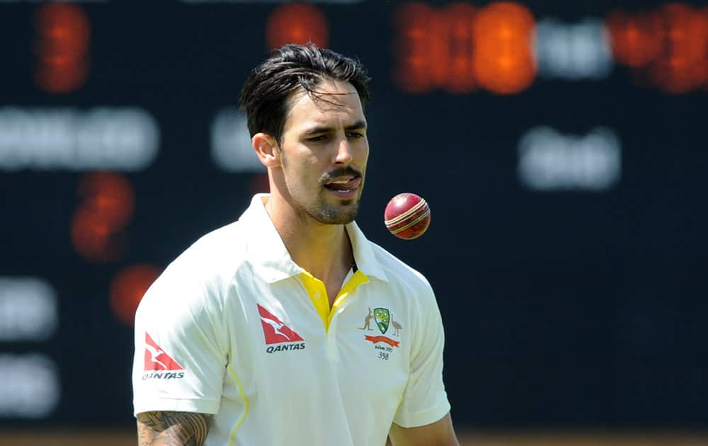 Australia’s Mitchell Johnson looks at the ball during day three of the first Ashes Test cricket match, in Cardiff, Wales.