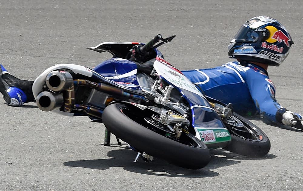 Honda rider Enea Bastianini of Italy crashes during the Moto3 free practice at the Sachsenring circuit in Hohenstein-Ernstthal, Germany.