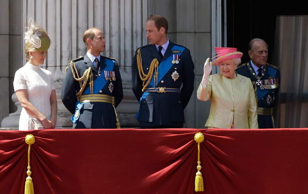 Britain's Queen Elizabeth II, waves beside from left, Sophie Countess of Wessex, Prince Edward, Prince William and her husband Prince Philip after they watched a Royal Air Force flypast to mark the 75th anniversary of the Battle of Britain from a balcony at Buckingham Palace, in London.