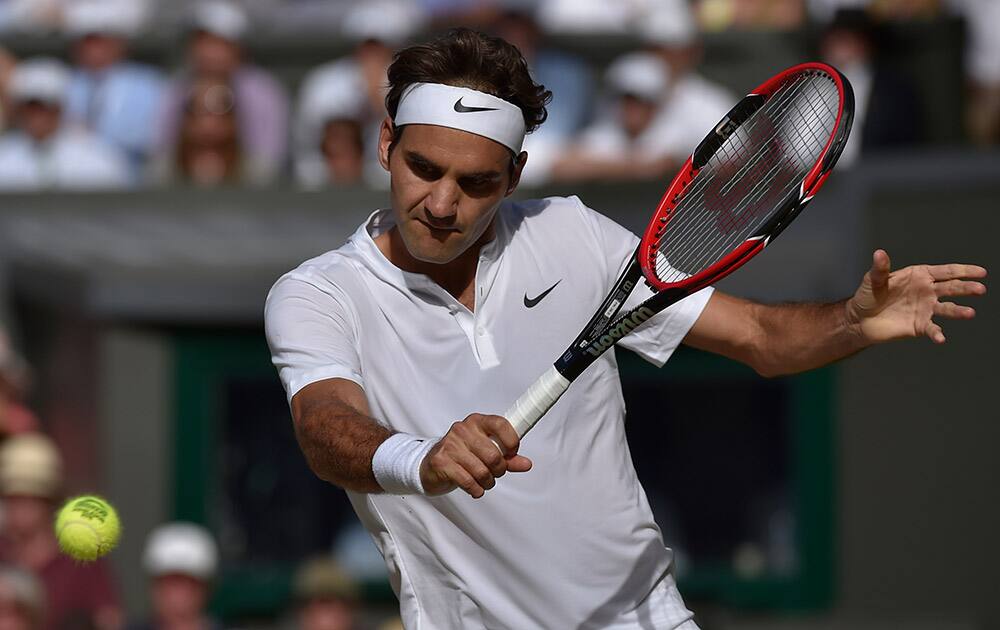 Roger Federer of Switzerland returns a shot to Andy Murray of Britain, during the men's singles semifinal match at the All England Lawn Tennis Championships in Wimbledon.