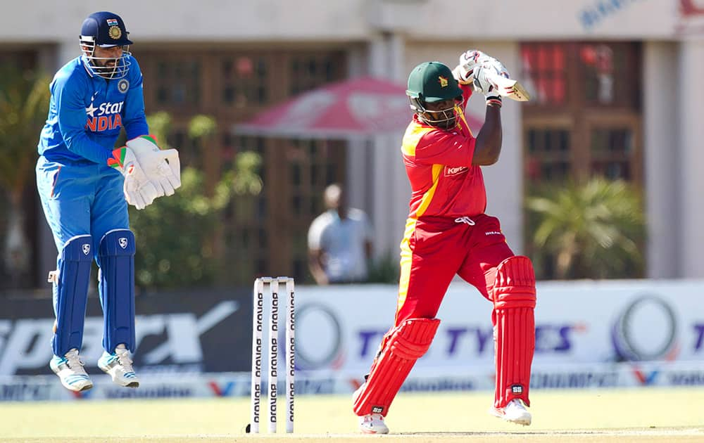 Zimbabwean batsman Hamilton Masakadza, right, plays a shot as Indian wicketkeeper Robin Utappa reacts during the One Day International in Harare, Zimbabwe.