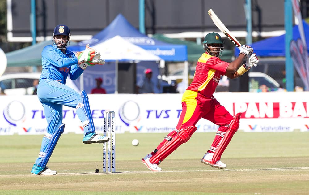 Zimbabwean batsman Hamilton Masakadza, right, plays a shot as Indian wicketkeeper Robin Utappa reacts during the One Day International against Zimbabwe in Harare, Zimbabwe.