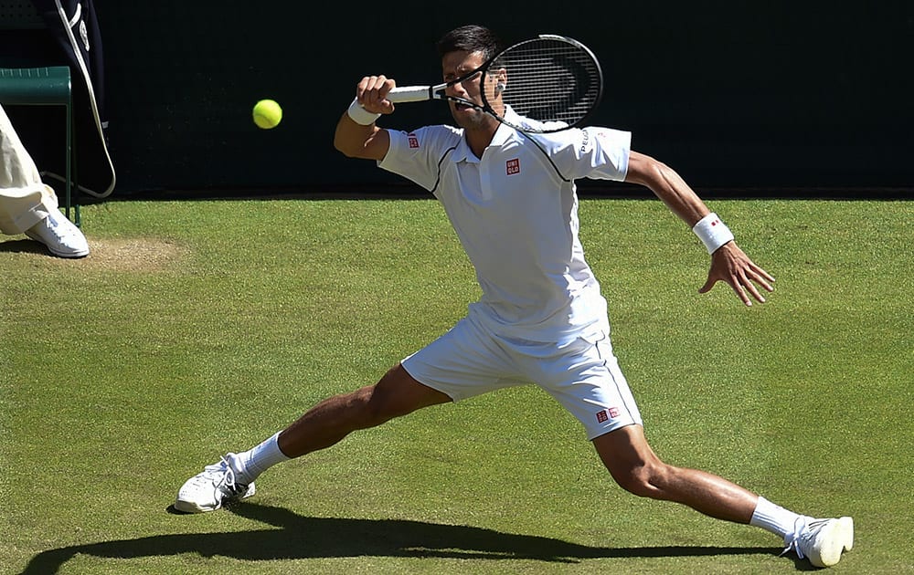 Novak Djokovic of Serbia returns a shot to Richard Gasquet of France during their men's singles semifinal match at the All England Lawn Tennis Championships in Wimbledon.