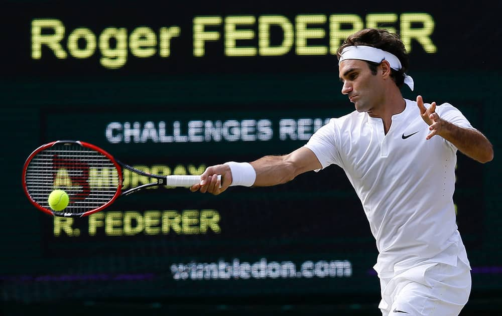 Roger Federer of Switzerland returns a shot to Andy Murray of Britain, during their men's singles semifinal match at the All England Lawn Tennis Championships in Wimbledon, London.