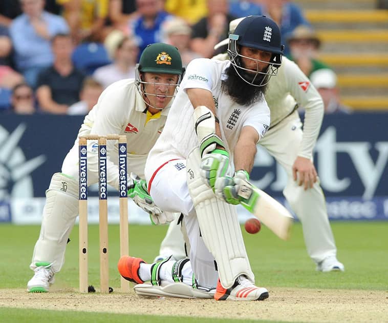 England’s Moeen Ali plays a shot during day three of the first Ashes Test cricket match.