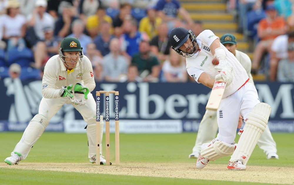 England’s Mark Wood hits a six of Australia's Nathan Lyon bowling during day three of the first Ashes Test cricket match, in Cardiff, Wales.