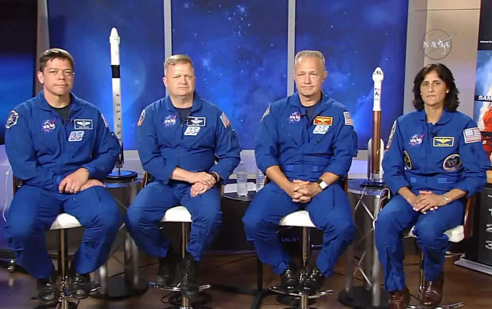 In this image made from video provided by NASA, astronauts, from left, Bob Behnken, Eric Boe, Doug Hurley and Sunita Williams gather for an interview at the Johnson Space Center.