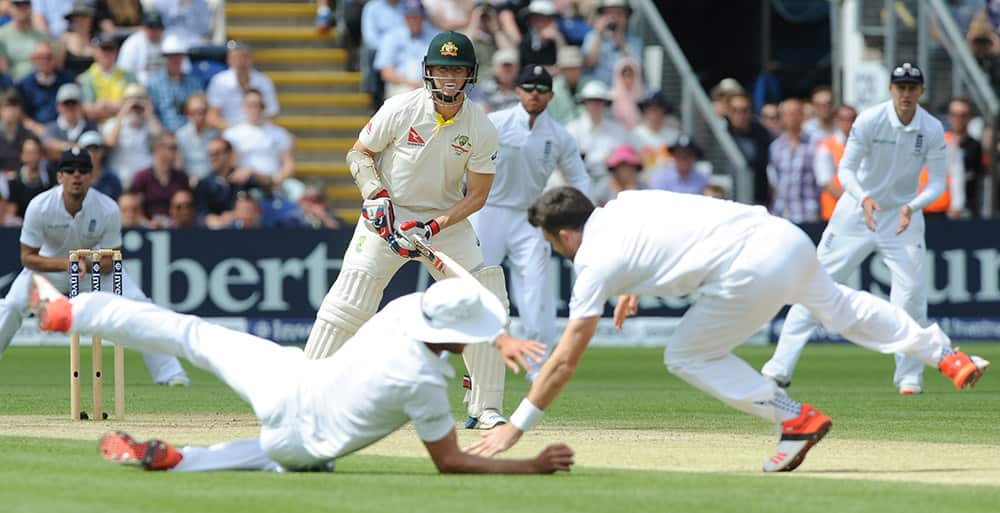 England’s Stuart Broad and James Anderson attempt to catch Australia’s Chris Rogers during day four of the first Ashes Test cricket match, in Cardiff, Wales.