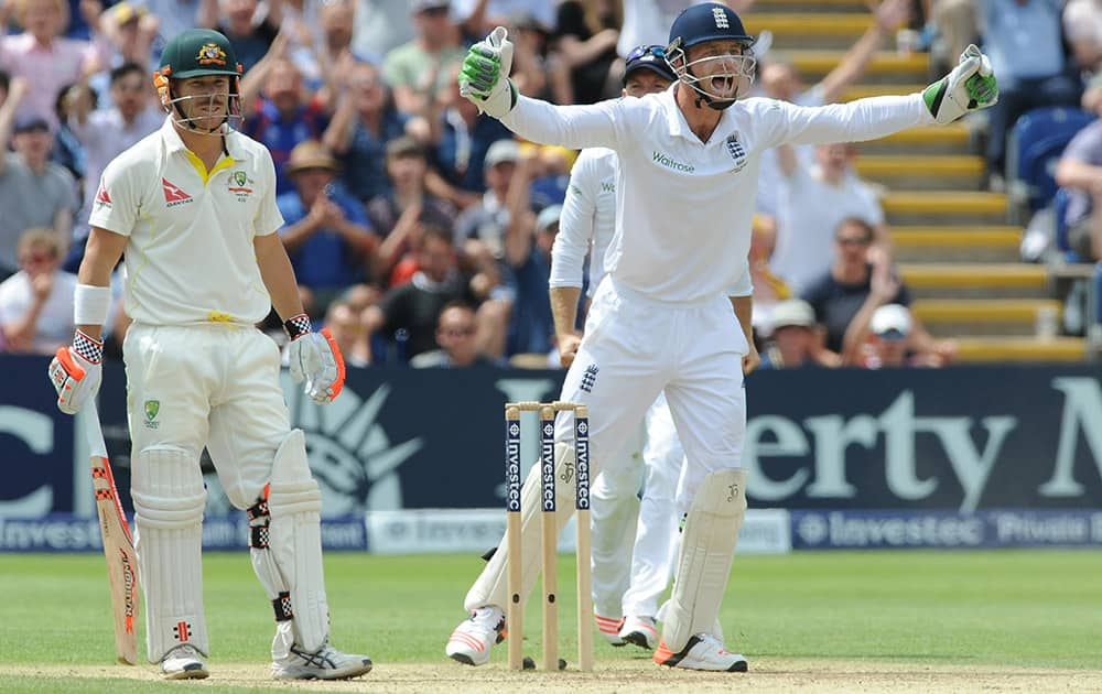 England’s Jos Buttler celebrates after Australia’s David Warner is trapped LBW by England’s Moeen Ali for 52 runs during day four of the first Ashes Test cricket match, in Cardiff, Wales.