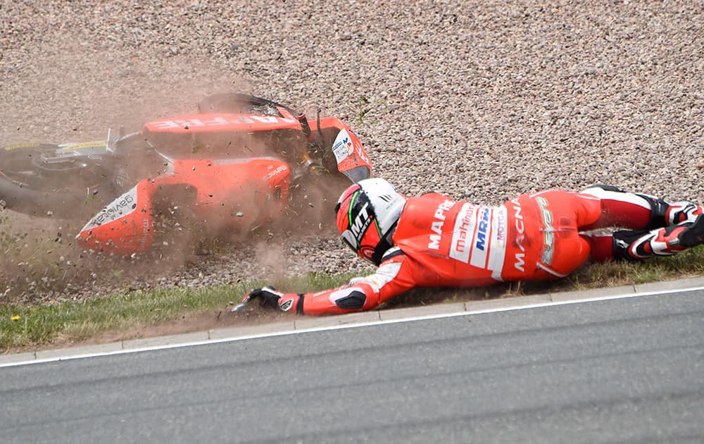 Spain's Juanfran Guevara crashes during the Moto3 qualifying at the Sachsenring circuit in Hohenstein-Ernstthal, Germany.