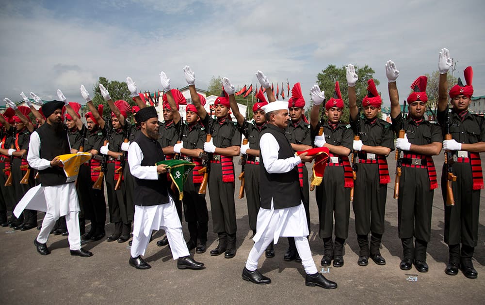 Sikh, Muslim and Hindu priests hold holy books as Indian Army Jammu Kashmir Light Infantry Regiment’s (JKLIR) newly raised soldiers take oath during a passing out parade on the outskirts of Srinagar.
