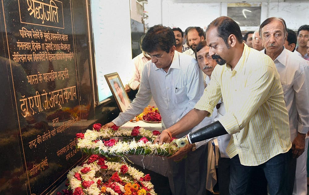 Mahendra Pitale who lost his hand in 7/11 Mumbai blasts, paying homage at a memorial for the victims of blasts on the anniversary of the incident in Mumbai.