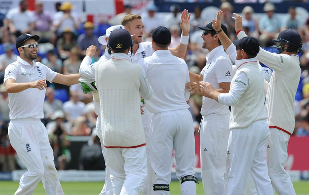 England’s Stuart Broad celebrates after bowling Australia’s Michael Clarke caught Ben Stokes for 4 runs during day four of the first Ashes Test cricket match, in Cardiff, Wales.