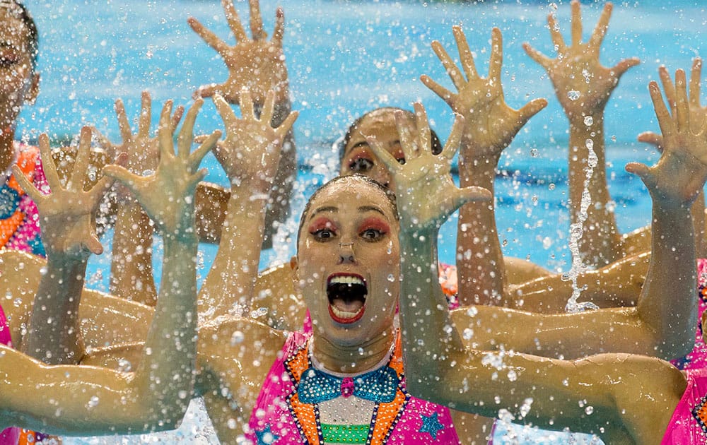 Members of Mexico's synchronised swimming team perform a clown inspired number for their free routine at the Pan Am Games in Toronto.