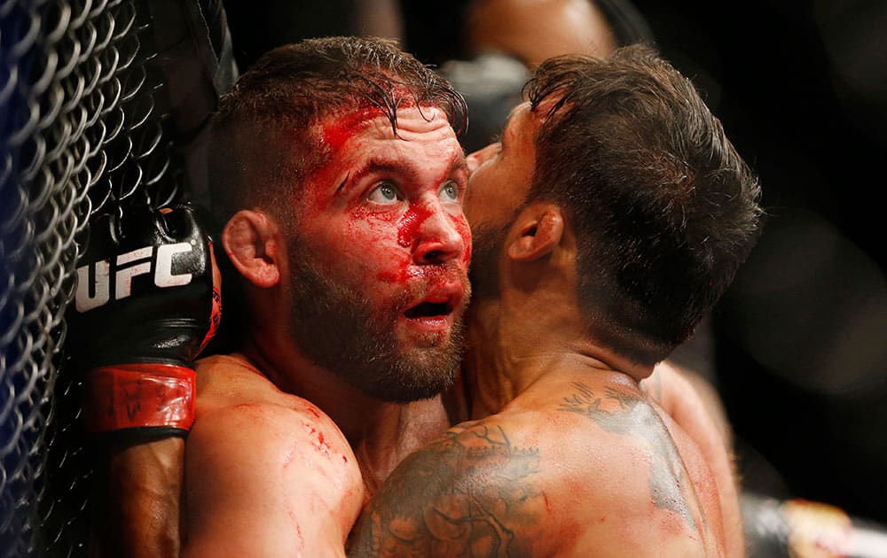 Jeremy Stephens, left, fights Dennis Bermudez during their mixed martial arts bout at UFC 189, in Las Vegas.