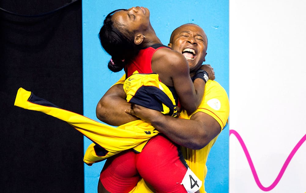 Ana Iris Segura Segura, left, of Colombia is hugged by her coach after winning the silver medal in women's 48kg weightlifting at the 2015 Pan Am Games in Toronto.