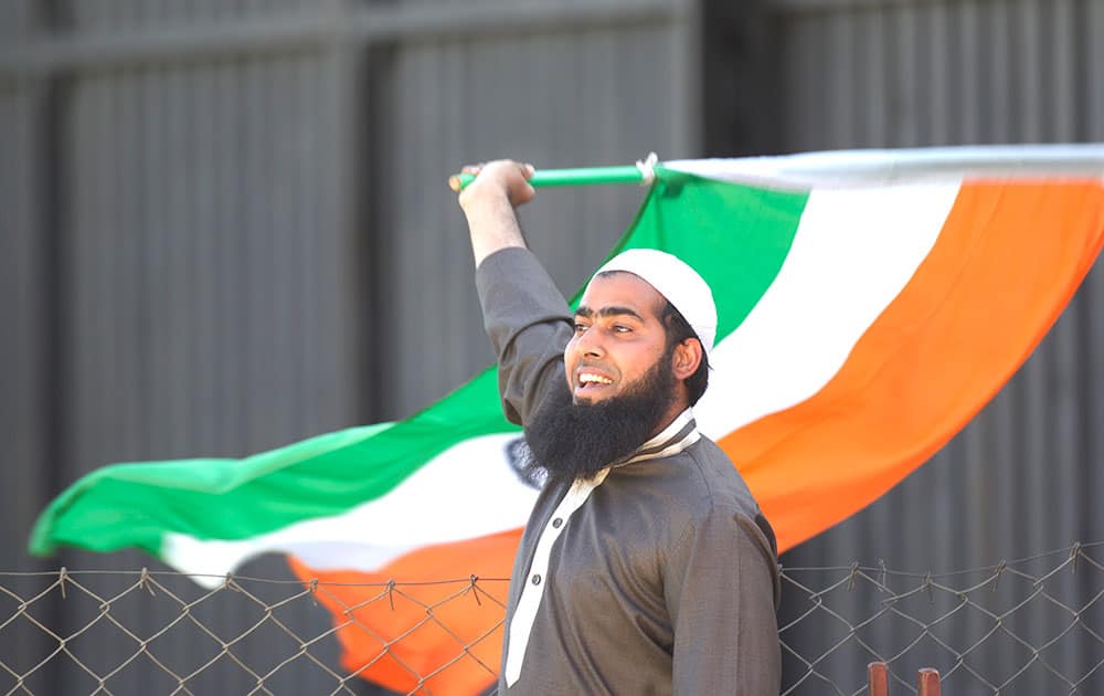 An Indian cricket fan waves the Indian flag on the second One Day International cricket match between India and Zimbabwe in Harare, Zimbabwe.