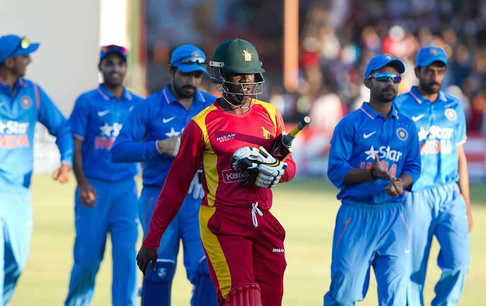 Zimbabwean and Indian cricket players walk off the pitch after the match on the second day of the One Day International cricket match between the two teams in Harare, Zimbabwe.